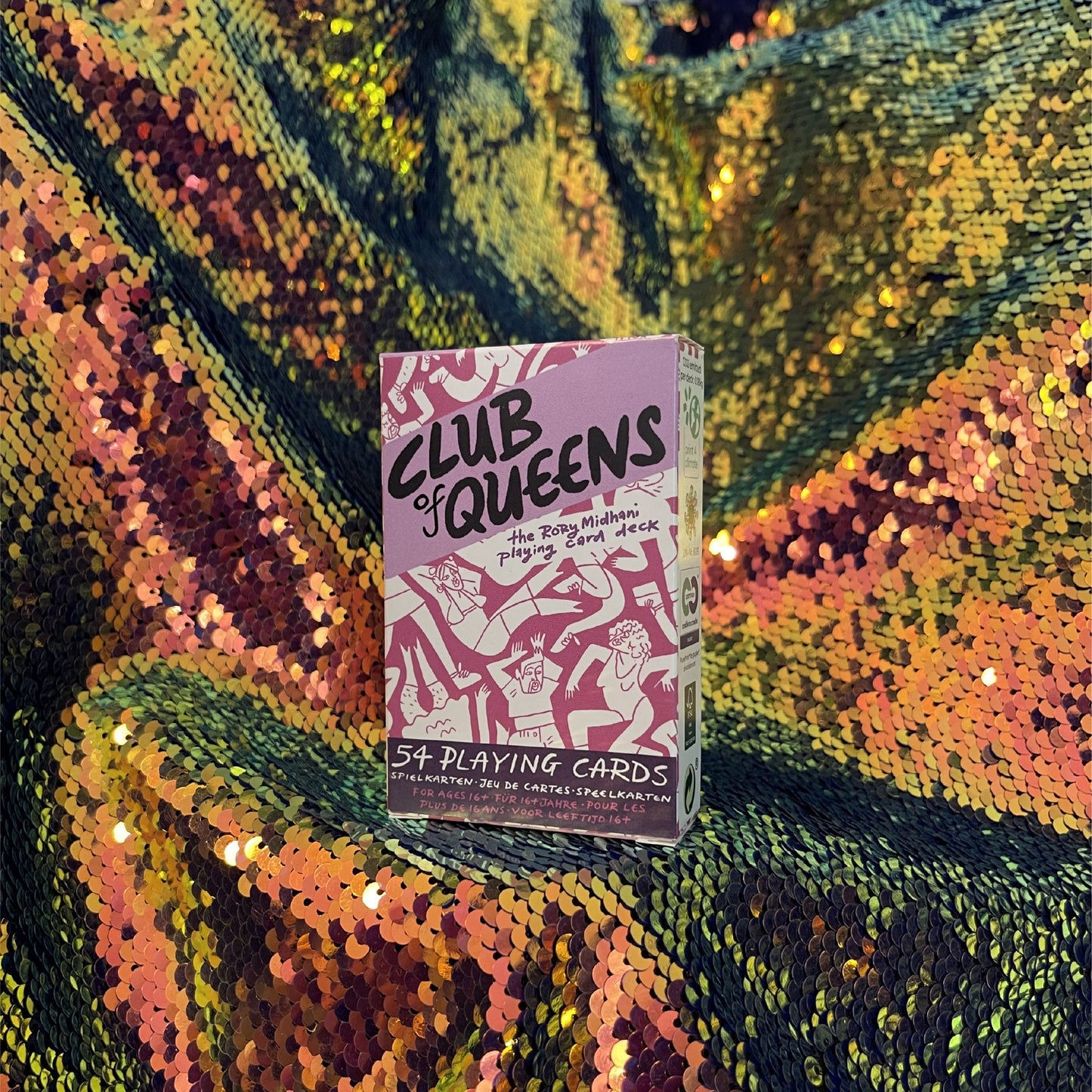 Club of Queens playing cards against a yellow-blue-green sequined background.