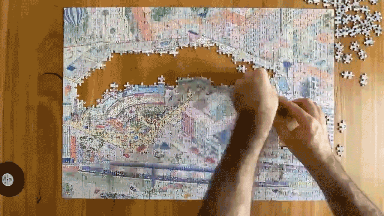 A stop-motion GIF of a puzzle in various stages until completion. The puzzle graphic is of Kottbusser Tor in Berlin Kreuzberg. The puzzle is done on a light wooden table.