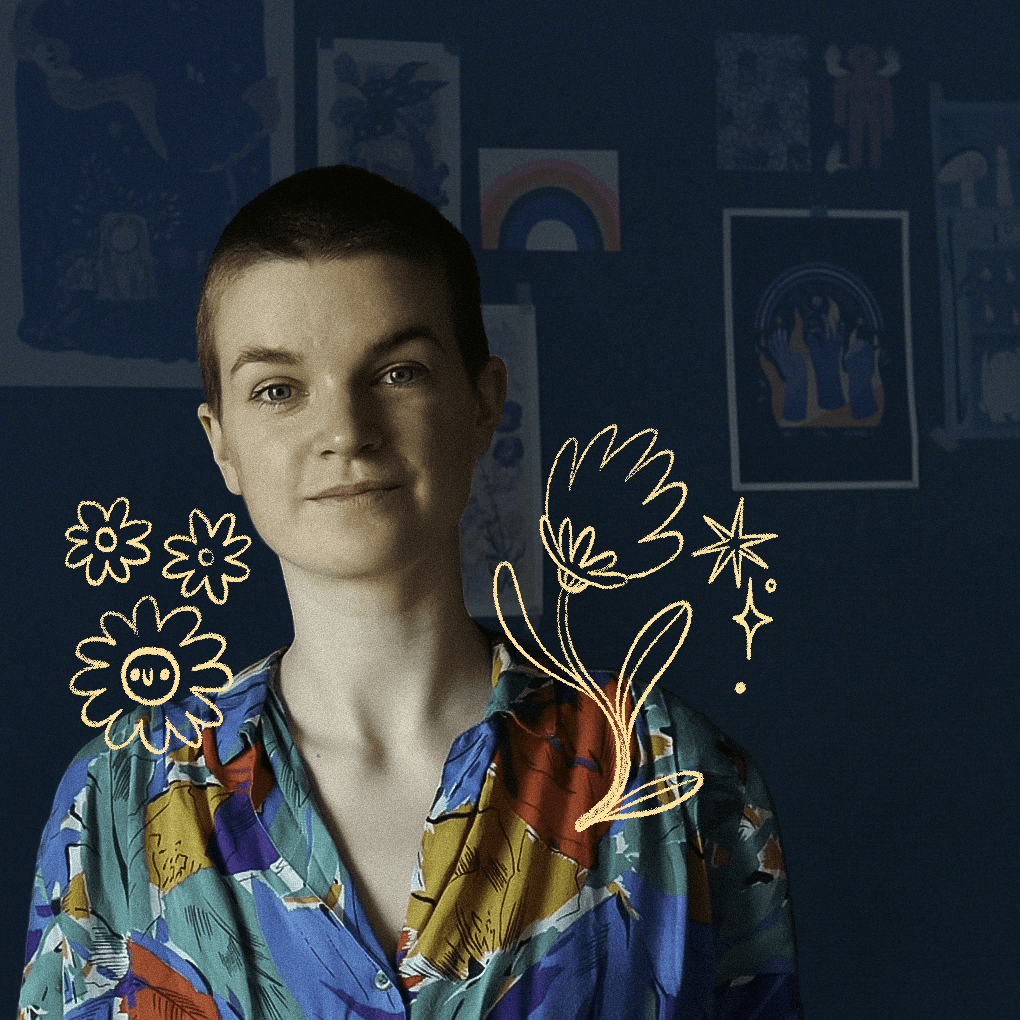 A portrait of the artist Louie Läuger, against a dark green background with artwork on a wall. Around their shoulders are cute flower and sparkly illustrations, and they are wearing a colorful print shirt. They have light skin, a shaved head of brown hair, and brown eyes.
