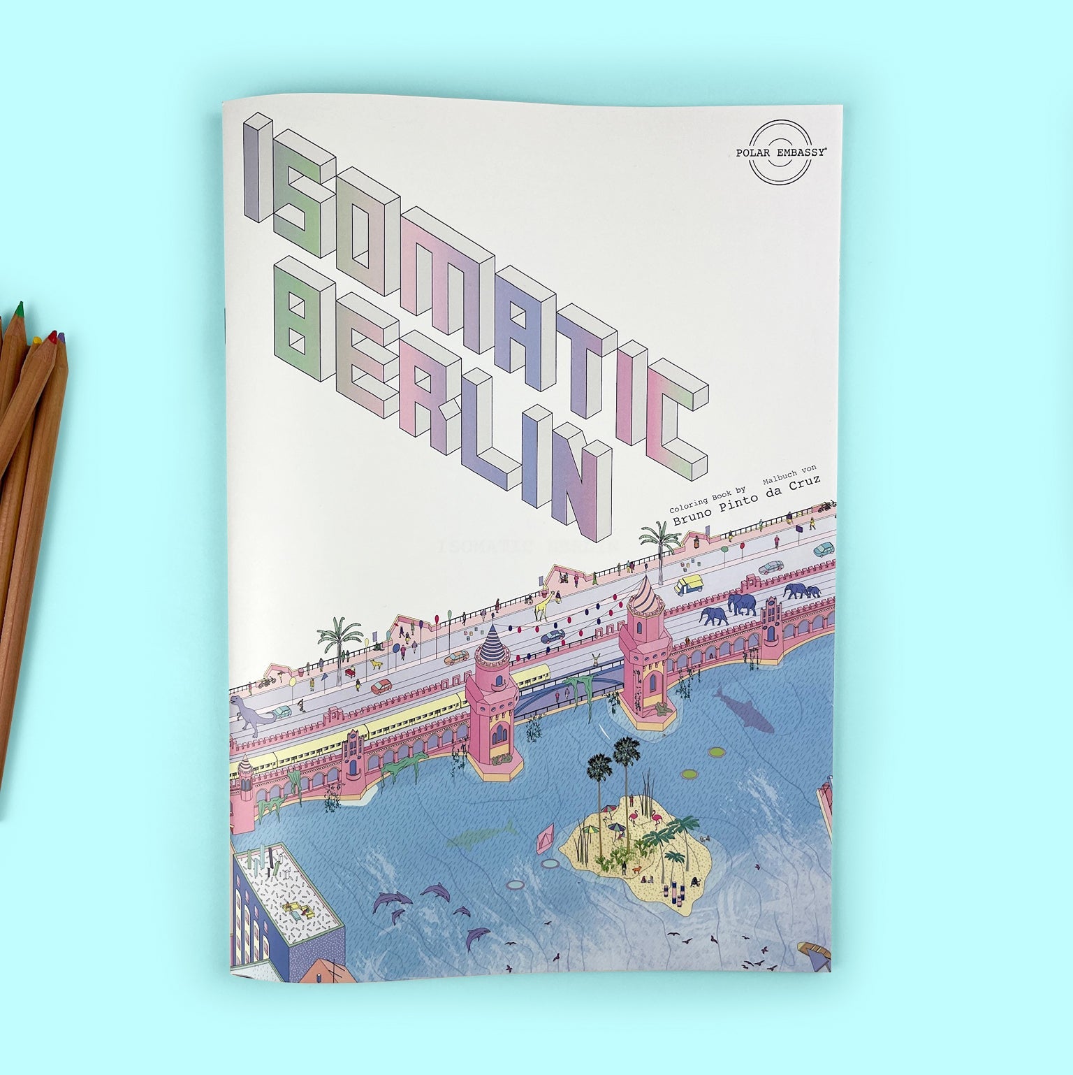 A Berlin Coloring Book published by Polar Embassy on a blue background with coloring pencils just in frame on the left