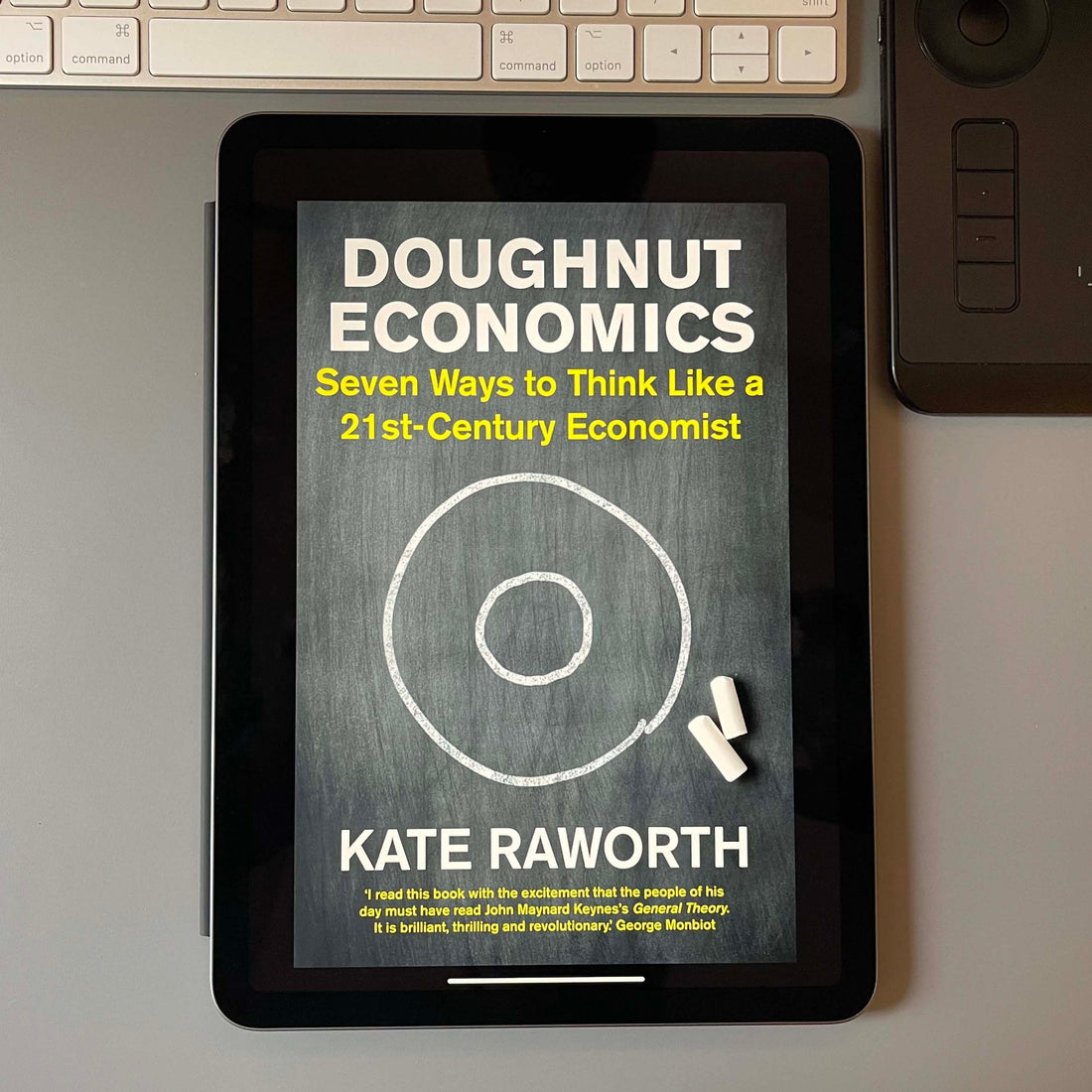 iPad with the cover of Doughnut Economics by Kate Raworth.