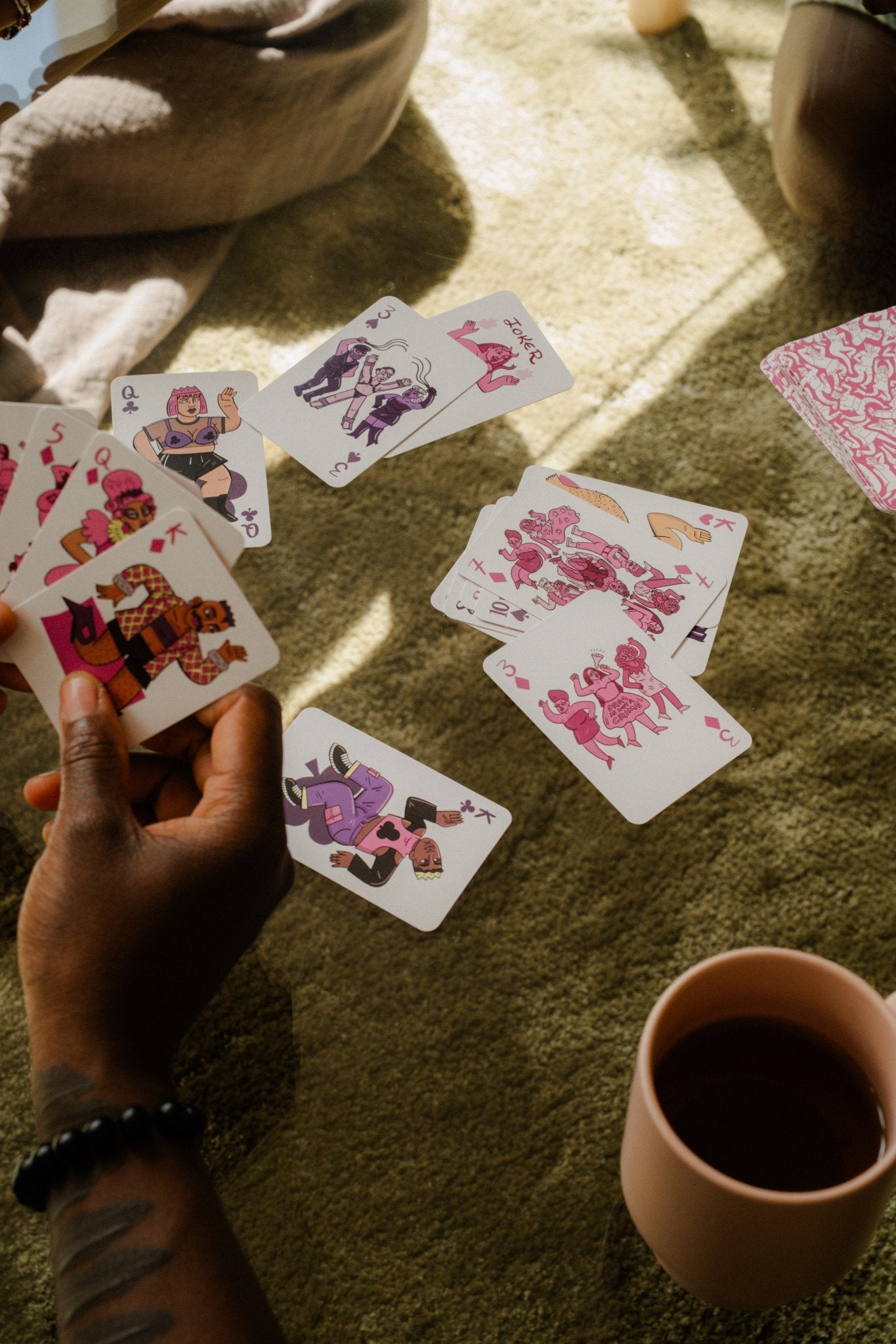 Playing the Three of Diamonds "Drag Is Not A Crime" card from Club of Queens queer playing cards.