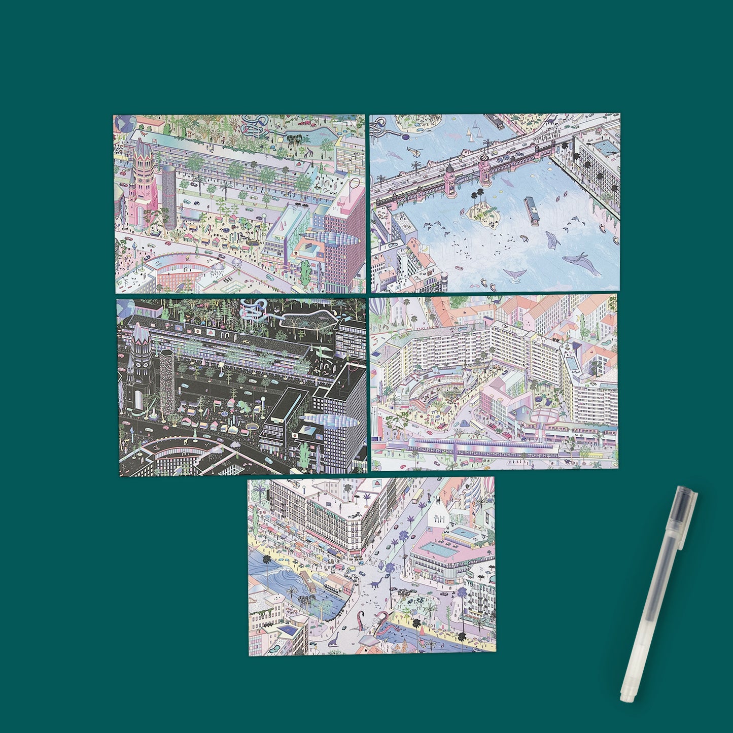 Five postcards lay against a dark green background next to a soft plastic pen. The postcards show bright colourful illustrations of Berlin.