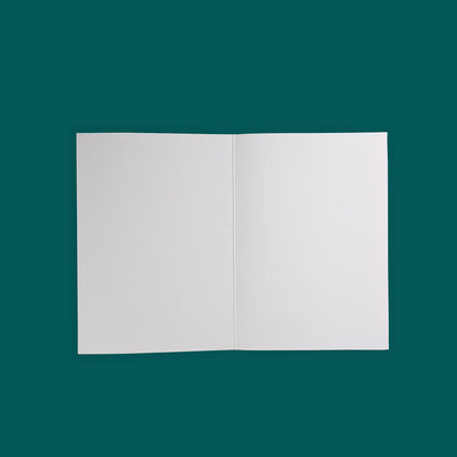 Blank white greeting card open against a glacial green background.