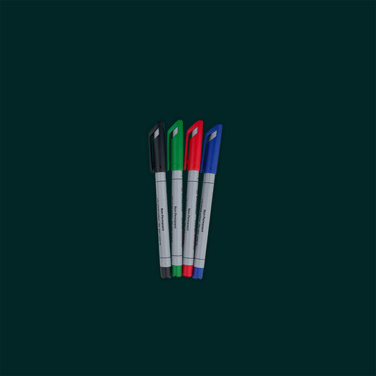 Four markers with black, green, red, and blue caps on a dark green background