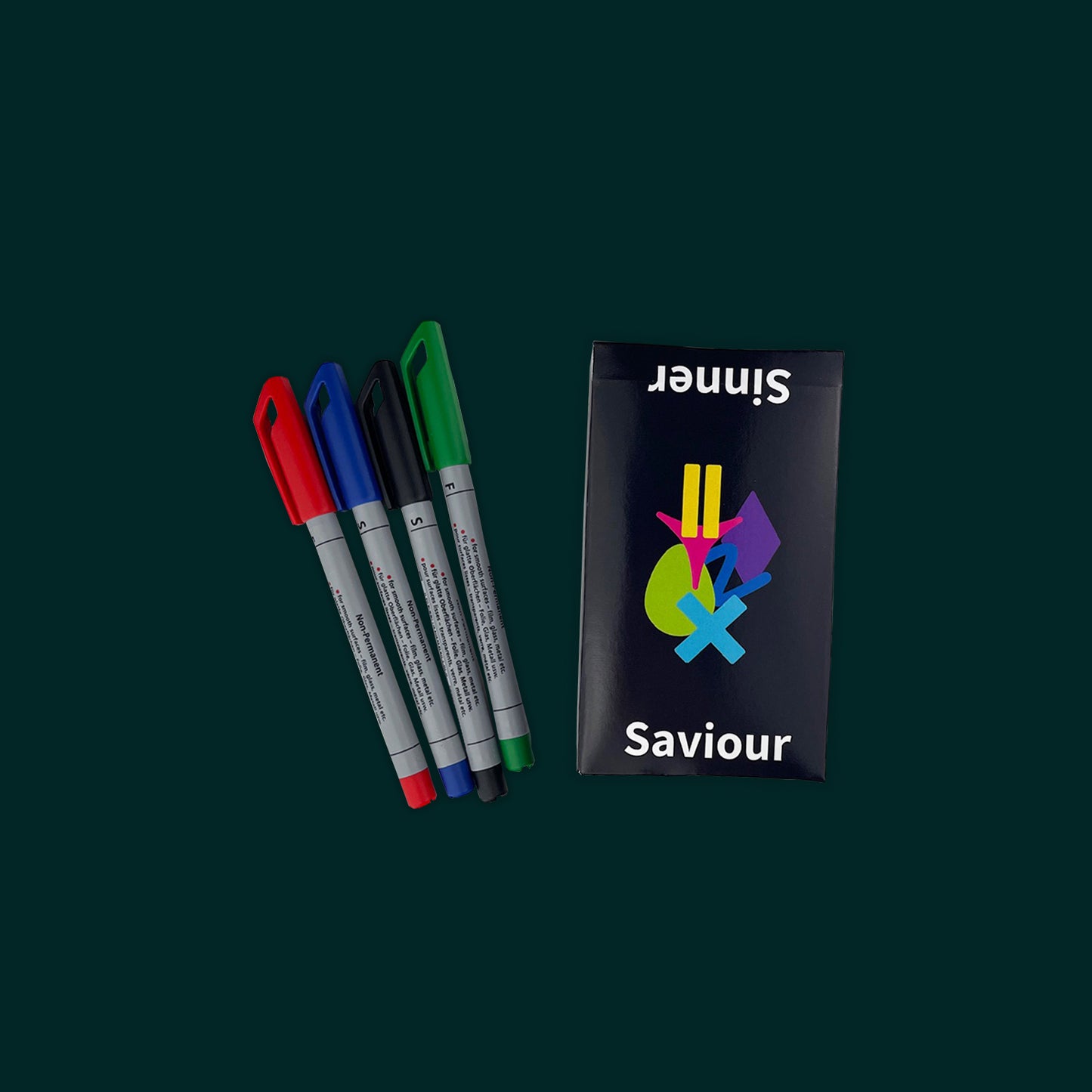 A boxed set of the educational game Sinner or Saviour sits on a dark green background, along with four dry erase markers used for the scorecards.