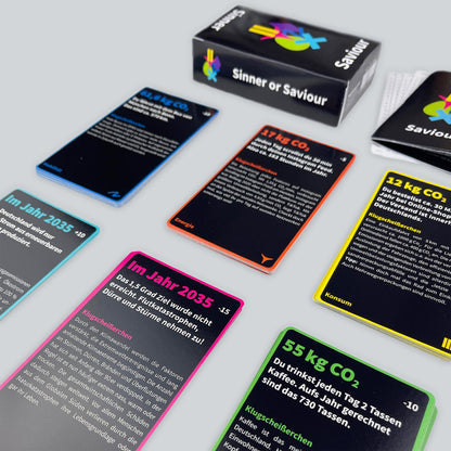 Playing cards from Sinner or Saviour stacked in respective piles of their categories (Mobility, Energy, etc.), against a light gray background.