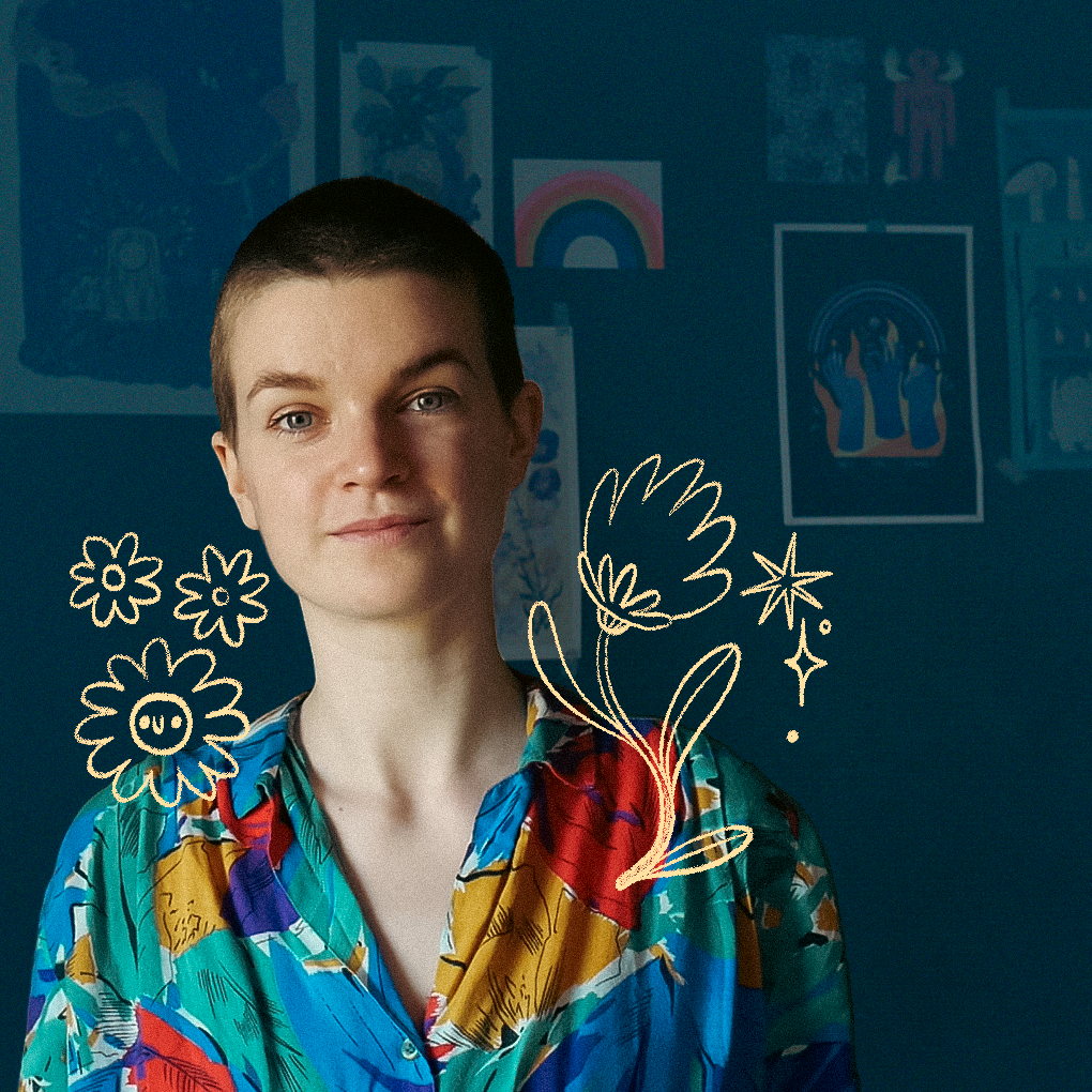 A portrait of the artist Louie Läuger, against a dark green background with artwork on a wall. Around their shoulders are cute flower and sparkly illustrations, and they are wearing a colorful print shirt. They have light skin, a shaved head of brown hair, and brown eyes. 