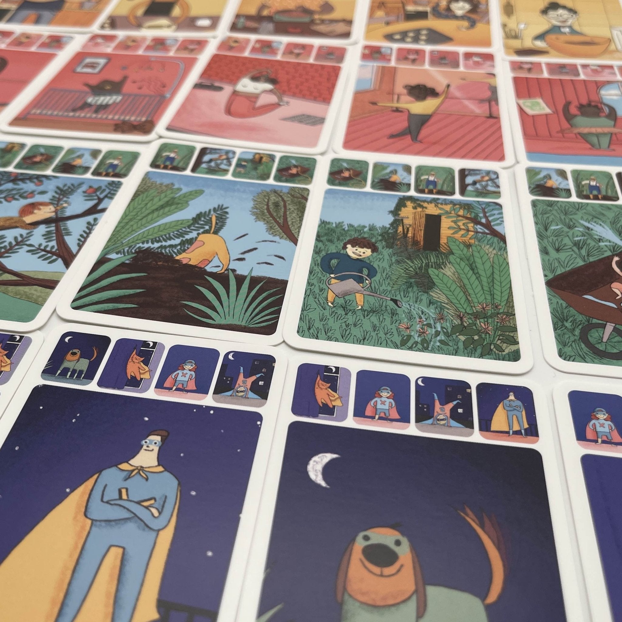 Details of Merry Families inclusive kids card game, showing superhero parents and dogs, and kids playing in a garden.