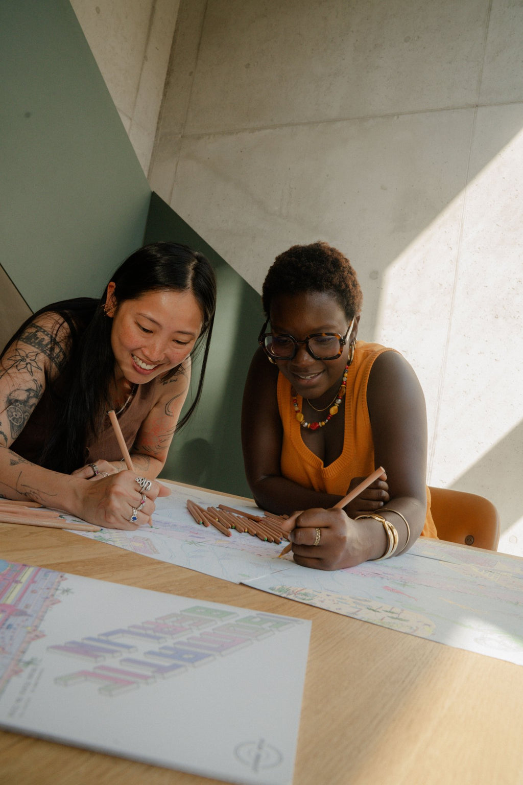Two friends colouring the Berlin Coloring Book for adults together, Isomatic art by Bruno Pinto da Cruz.