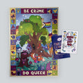 A colorful jigsaw puzzle with queer woodland creatures, alongside two workbooks by the artist Louie Läuger.