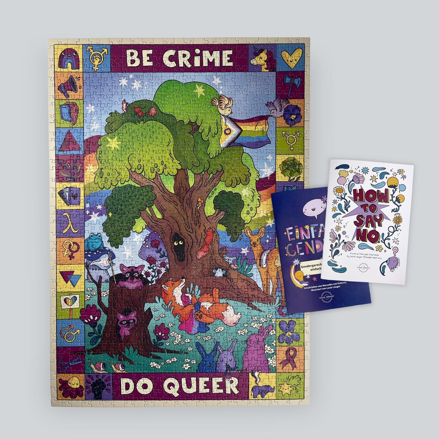 A colorful jigsaw puzzle with queer woodland creatures, alongside two workbooks by the artist Louie Läuger.