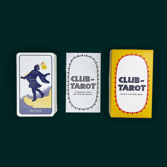 Deck of Tarot Cards in the style of Club Mate on a dark green background. The box is yellow and red, the guidebook is in black and white, and on the left is a pile of Tarot cards with the Fool on top.