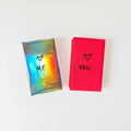 Two gift-wrapped Polar Embassy tarot decks: one in rainbow paper with “ME” and heart, one in pink paper with “YOU” and heart
